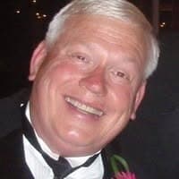 Donald Begley smiling in a tuxedo